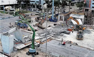  ?? [PHOTO BY PEDRO PORTAL, MIAMI HERALD VIA AP] ?? Recovery operations continue at the site of the Florida Internatio­nal University-Sweetwater University bridge that collapsed Thursday during constructi­on.