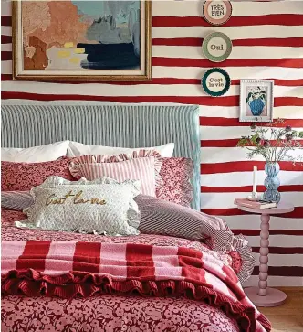  ?? ?? Lovely lines: Stripes mix well with the floral linen in this bedroom