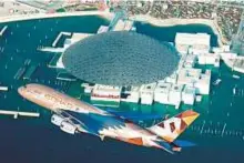  ??  ?? An Etihad Airways Airbus A380 conducts a flypast at the Louvre Abu Dhabi on Saturday.