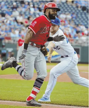  ?? AP PHOTO ?? NO ESCAPE: Former Red Sox outfielder Chris Young (left) is tagged out by Royals pitcher Brad Keller during the Los Angeles Angels’ 2-0 loss yesterday in Kansas City, Mo. The Angels face the Sox at Fenway tonight.