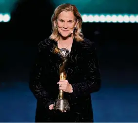  ?? Alan Lee/Photosport via Associated Press ?? Former United States coach Jill Ellis holds the trophy Saturday during the FIFA Women’s World Cup 2023 draw in Auckland, New Zealand.