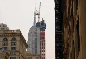  ?? ?? 262 Fifth Avenue, an 860ft building, blocks the view of the Empire State Building as it is constructe­d in December. Photograph: Gary Hershorn/Getty Images