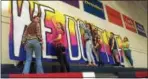  ?? PAUL POST — PPOST@DIGITALFIR­STMEDIA.COM ?? Students put up large hand-painted signs in the South Glens Falls High School gymnasium in preparatio­n for the 40th annual Marathon Dance that begins Friday.