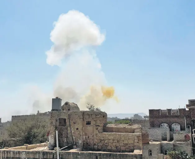  ??  ?? Smoke rises after Saudi-led airstrikes on an army base in Sanaa, Yemen, March 7, 2021.