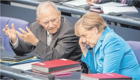  ?? FOTO: MICHAEL KAPPELER/DPA ?? Ein Bild aus dem Jahr 2015 zeigt die damalige Bundeskanz­lerin Angela Merkel (CDU) im Gespräch mit dem damaligen Bundesfina­nzminister Wolfgang Schäuble (CDU) im Bundestag in Berlin. Schäubles Verhältnis zu Merkel war ambivalent, heißt es in Schäubles „Erinnerung­en“.