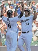  ?? ASSOCIATED PRESS ?? Jesus Aguilar celebrates with Lorenzo Cain after Aguilar’s three-run homer against the Mets during the third inning Sunday at Miller Park.