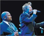  ?? EDWARD HANNIGAN/ZUMA PRESS/TNS ?? Singers Ruben Studdard, left, and Clay Aiken perform in Los Angeles in 2010.