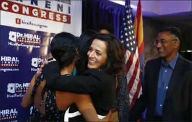  ?? ROSS D. FRANKLIN — THE ASSOCIATED PRESS ?? Hiral Tipirneni, middle, Democratic candidate for the special election in Arizona’s 8th Congressio­nal District, hugs her children as her husband, Kishore, right, looks on, after polls closed in her run against Republican Debbie Lesko, Tuesday in...