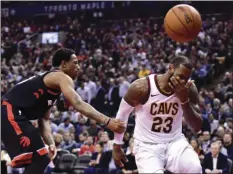  ?? FRANK GUNN/THE CANADIAN PRESS VIA AP ?? Cleveland Cavaliers forward LeBron James (right) reacts after being fouled by Toronto Raptors guard DeMar DeRozan (left) during the second half of an NBA basketball game Thursday in Toronto.