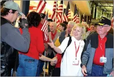  ?? Photo by Mike Eckels ?? A Vietnam War veteran (far left) salutes a comrade in arms from the Korean Conflict in one of the touching moments of the welcome home ceremony for the 2016 Honor Flight at Northwest Arkansas Regional Airport in Highfill April 20, 2016.