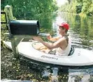  ?? RED HUBER/STAFF FILE PHOTO ?? Dan Schedivy, who lives on Lake Harney, kayaks to his mailbox after flooding brought on by Tropical Storm Fay in 2008.