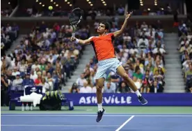  ?? Julian Finney/Getty Images ?? Carlos Alcaraz plays a backhand volley in the final against Casper Ruud. Photograph: