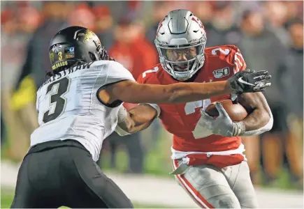  ?? RICK BOWMER/AP ?? Utah running back Zack Moss, getting wrapped up by Derrion Rakestraw, rushed for 88 yards and a TD as the Utes defeated Colorado 45-15.