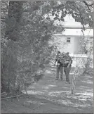  ?? Kevin Myrick / Standard Journal ?? Officers are stationed at a house just down from Santa Claus Road in Polk County on Friday afternoon, Sept. 29, following a Polk County Police Department detective being shot and killed a few hours earlier.