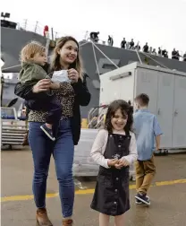  ?? JONATHON GRUENKE/STAFF ?? Mary Kate Adduce waits with her children Alaric, left, Philomena, center, and Damien, right, as the USS Stout returns to Naval Station Norfolk Monday morning. The USS Stout returns following a record-setting deployment that included more than 200 days at sea.