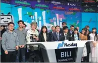  ?? XINHUA ?? Chen Rui (center), chairman of Bilibili Inc, and his colleagues attend the company’s stock trading debut on the Nasdaq in New York on Wednesday.