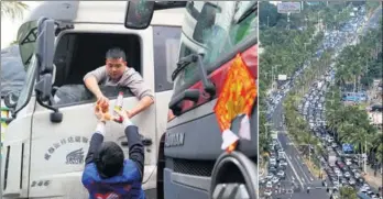  ?? ZHANG MAO, ZHANG JIE AND HONG JIANPENG FOR CHINA DAILY ?? A volunteer offers food and drinks to a driver stranded by a traffic jam in Haikou, Hainan province, on Wednesday, after heavy fog halted ferry service across the Qiongzhou Strait on Tuesday.