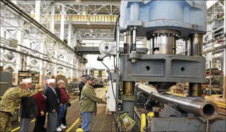  ?? JOHN B. SNYDER — WATERVLIET ARSENAL ?? Machinist Ryan Putnam puts hundreds of tons of pressure on a howitzer tube during a visit to the Watervliet Arsenal by former New York American Legion Department Commander John Sampson in January 2017.