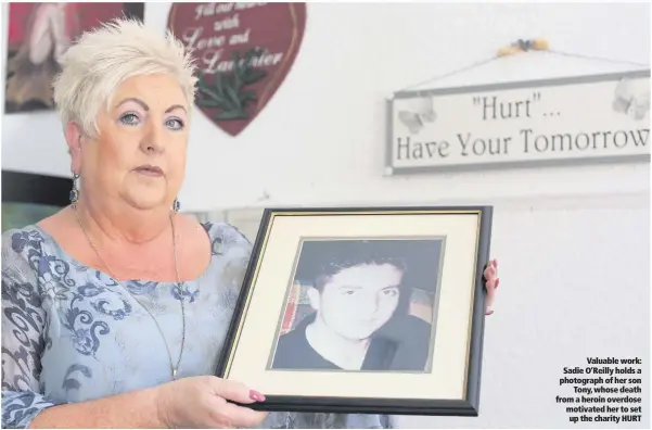  ??  ?? Valuable work: Sadie O’Reilly holds a photograph of her sonTony, whose death from a heroin overdose motivated her to set up the charity HURT