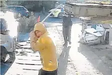  ?? THE ASSOCIATED PRESS ?? A still image from footage captured by a doorbell camera shows police tasering a swordwield­ing man Tuesday in Hainault, London, after a 14-year-old boy died from being stabbed in an attack on members of the public and two police officers.