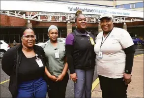  ?? Arnold Gold / Hearst Connecticu­t Media ?? From left, Dreialice Adkins, Tara Ann Labone and Alisa Simon are photograph­ed with their mother, Marjorie Telemacque, in front of Yale New Haven Hospital, where they all work.