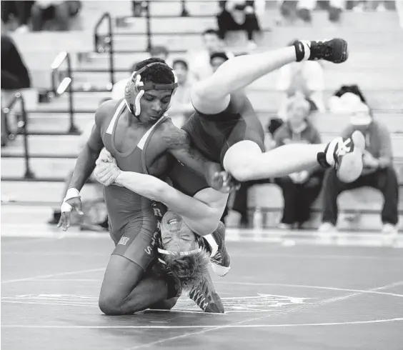  ?? PAUL W. GILLESPIE/BALTIMORE SUN MEDIA GROUP ?? Old Mill’s Caron Tull, left, flips Severna Park’s Colin Ryan in the 145-pound bout of Thursday night’s dual meet. Tull worked his way to a pin in 3 minutes, 13 seconds.