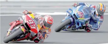  ?? — AFP photo ?? Marc Marquez (le ) leads Alex Rins during the Moto GP race of the British Grand Prix at Silverston­e circuit in Northampto­nshire, central England.