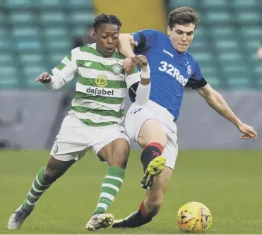  ??  ?? 0 Celtic’s Karamoko Dembele vies with Jamie Barjonas of Rangers in the City of Glasgow Cup final.