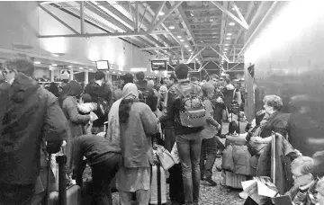  ??  ?? Passengers are stranded at the Stansted airport after cold snap hits London in this still image taken from a video. — Reuters photo