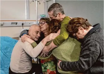  ?? Israeli army/associated Press photos ?? Relatives embrace former hostage Louis Har, 70, at the Sheba Medical Center in Ramat Gan, Israel, on Monday after he was rescued by Israeli forces in Rafah, Gaza Strip.