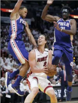  ?? LYNNE SLADKY — THE ASSOCIATED PRESS ?? Miami’s Kelly Olynyk (9) attempts to shoot as the 76ers’ Justin Anderson, left, and Joel Embiid (21) defend during the second half Game 3 Thursday in Miami. The 76ers won, 128-108. of