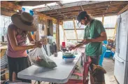  ??  ?? Angela Lee and Wes O’rourke prepare a communal meal in the community space at Sol Mountain Farm in South Fork, which was founded in 1882.