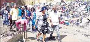  ?? (File pic) ?? Director of SMEs Mluleki Dlamini (R), who was representi­ng the Minister of Commerce, Industry and Trade Manqoba Khumalo, inspecting the damages at (Bend n Pick) storage room in Manzini, together with Thobile Dube, who is the Chairperso­n of and other members.