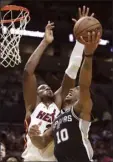  ?? AP photo ?? Hassan Whiteside of the Heat defends the Spurs’ DeMar DeRozan in the second half Wednesday.