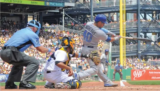  ?? | JUSTIN BERL/ GETTY IMAGES ?? The Cubs’ Willson Contreras smacks a two- run double to left field in the third inning Sunday against the Pirates. He was 3- for- 5 with three RBI.