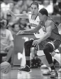  ?? AP/JOHN MILLER ?? Arizona’s Nick Johnson (back) and New Mexico State’s Daniel Mullings battle for a loose ball during Wednesday night’s game in Tucson, Ariz.