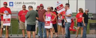  ?? DAVE CHIDLEY, THE CANADIAN PRESS ?? Members of Unifor Local 88 walked off the job Sept. 17 as negotiator­s worked to have GM designate the plant as the lead producer of the Equinox SUV.