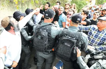  ?? (Olivier Fitoussi/Flash90) ?? SECURITY FORCES clash with protesters in Sheikh Jarrah this week.