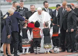  ?? Alessandra Tarantino The Associated Press ?? Pope Francis is welcomed by children wearing traditiona­l dresses upon his arrival Sunday in Sofia, Bulgaria, for a two-day visit.
