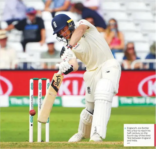  ?? AFP ?? England’s Jos Buttler hits a four to reach his half-century on the fourth day of the third Test between England and India.