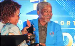  ?? ?? ▲Retired sports administra­tor Maswazi Shongwe recieving his hononary awards from Acting Minister of Sports Jane Mkhota.