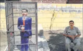  ?? PTI ?? ▪ A statue of Dr Bhimrao Ambedkar locked in an iron cage, in Badaun on Thursday. After several instances of the Dalit icon’s statues getting vandalised, and in one instance painted saffron, across Uttar Pradesh, the administra­tion is looking to ward...