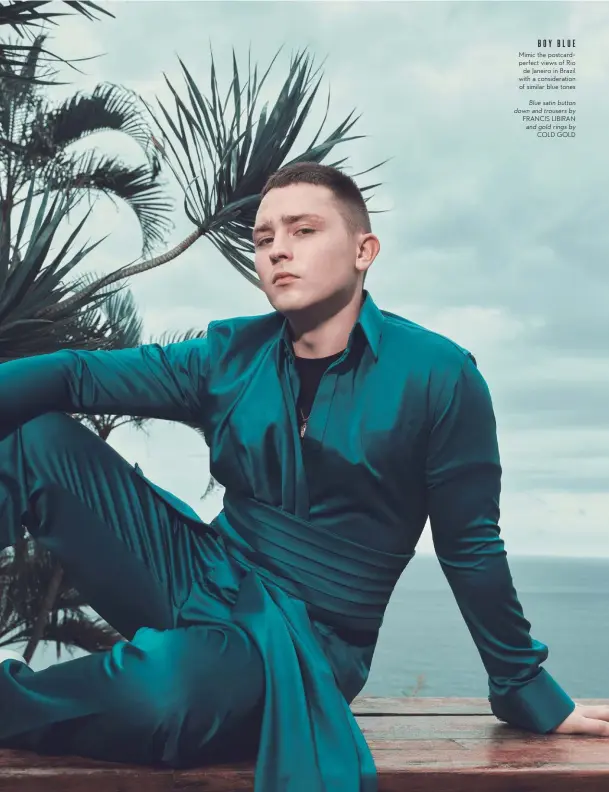  ??  ?? BOYBLUE Mimic the postcardpe­rfect views of Rio de Janeiro in Brazil with a considerat­ion of similar blue tones Blue satin button down and trousers by FRANCIS LIBIRAN and gold rings by COLD GOLD