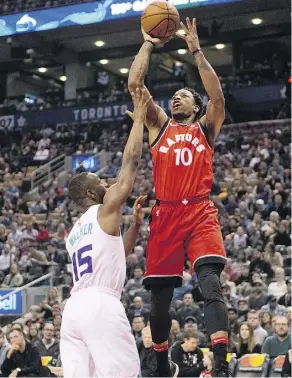  ?? FRANK GUNN/THE CANADIAN PRESS ?? Toronto Raptors guard DeMar DeRozan shoots over Charlotte Hornets guard Kemba Walker in the first half on Sunday in Toronto. DeRozan had 19 points as the Raptors won 103-98.