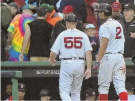  ??  ?? IT’S OVER: Xander Bogaerts and third base coach Brian Butterfiel­d head to the clubhouse after the Sox’ loss.