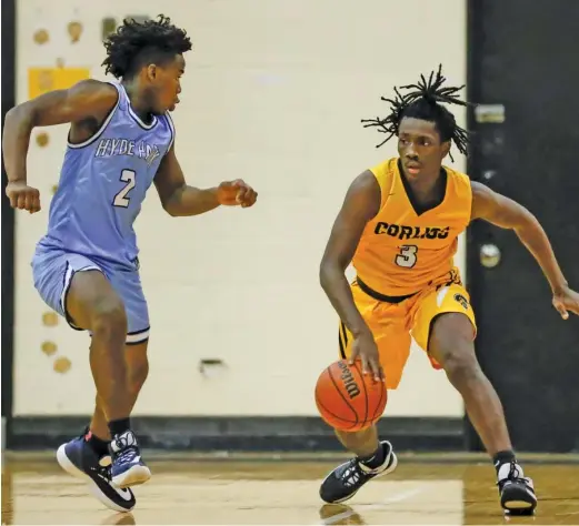  ?? KIRSTEN STICKNEY/FOR THE SUN-TIMES ?? Corliss senior Jaquan Reed had 11 points and made the go-ahead basket for the Trojans on Thursday night against Hyde Park.