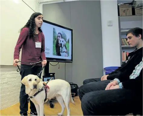  ?? ALLAN BENNER/STANDARD STAFF ?? Keely Grossman, with her service dog Izzy, discusses the humane treatment of animals during the Niagara Social Justice Forum at the Marilyn I Walker School of Fine and Performing Arts in St. Catharines, on Saturday.