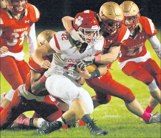  ?? JOHN SMIERCIAK/POST-TRIBUNE PHOTOS ?? Kankakee Valley running back Nathan Swafford (42) gets taken down by Andrean’s defense on Friday.