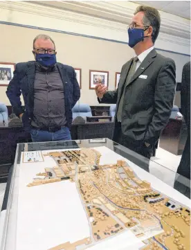  ?? KEITH GOSSE • THE TELEGRAM ?? Mount Pearl Mayor Dave Aker (left) and Deputy Mayor Jim Locke stand next to a model of a revitalize­d Mount Pearl city centre unveiled at a news conference at city hall Tuesday afternoon.