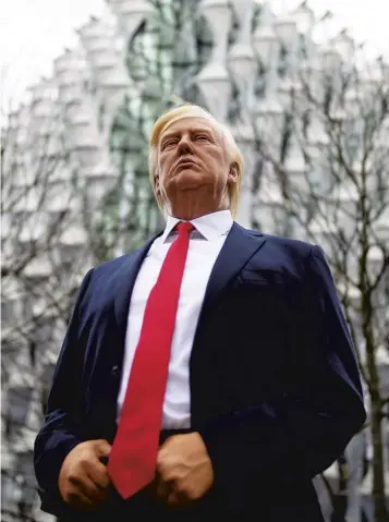  ??  ?? A model of Donald Trump from Madame Tussauds stands in for the president at the new US embassy in south London, which he has decided not to visit because he – wrongly – claimed his predecesso­r Barack Obama decided to relocate it to an ‘off location’.